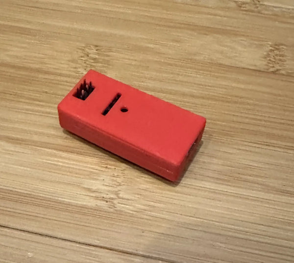 3D-printed snap-fit case enclosing an Arduino Nano microcontroller board on a maker workbench