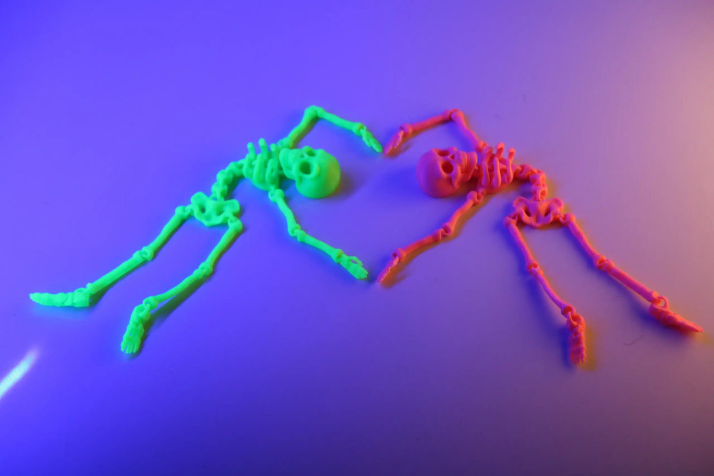 Articulated print-in-place 3D printed skeleton model posed on a desk, showing flexible ball-and-socket joints