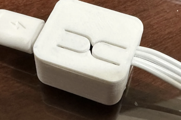 3D printed enclosure for the Adafruit QT PY ESP32-C3 board with wire passthrough openings