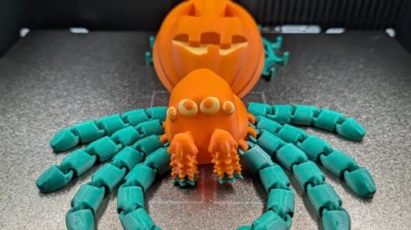 Articulated 3D-printed pumpkin spider with a retractable web mechanism in its abdomen